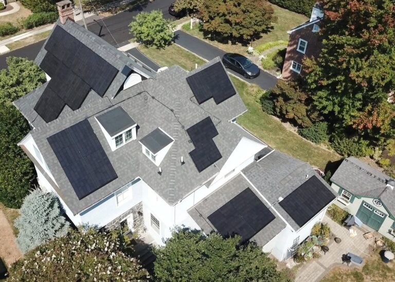 Large house with several solar panels on the roof