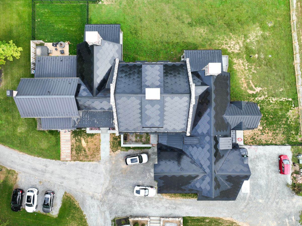 Aerial view of a large house with solar panels on the roof