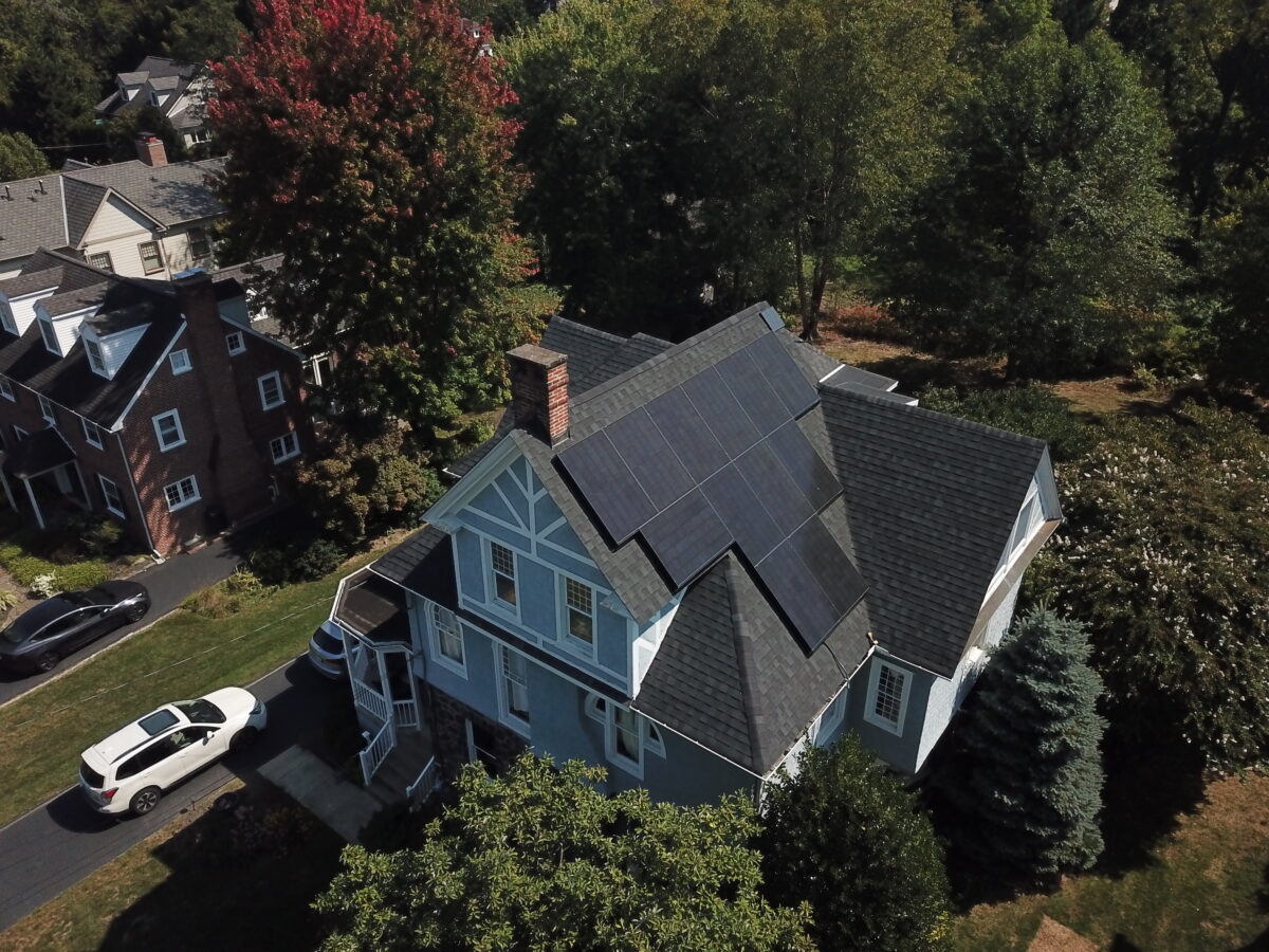 Aerial view of a house with solar panels on the roof