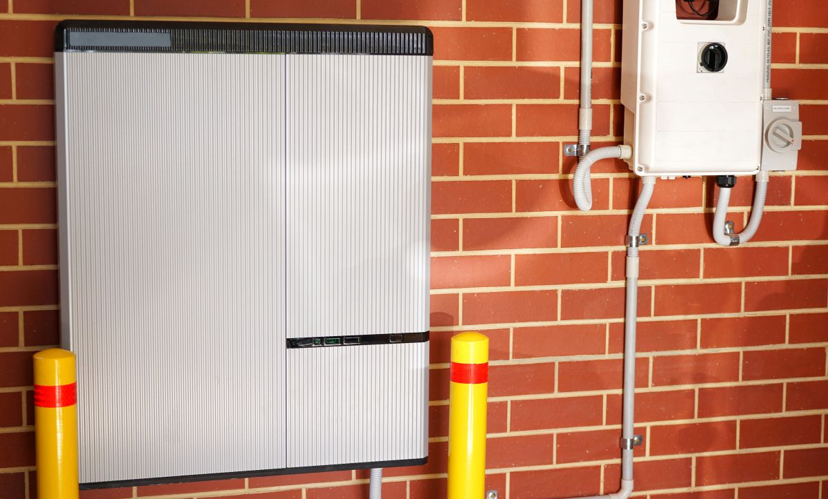 Lithium ion home battery and solar inverter solar panel system for domestic power storage installed in home garage.