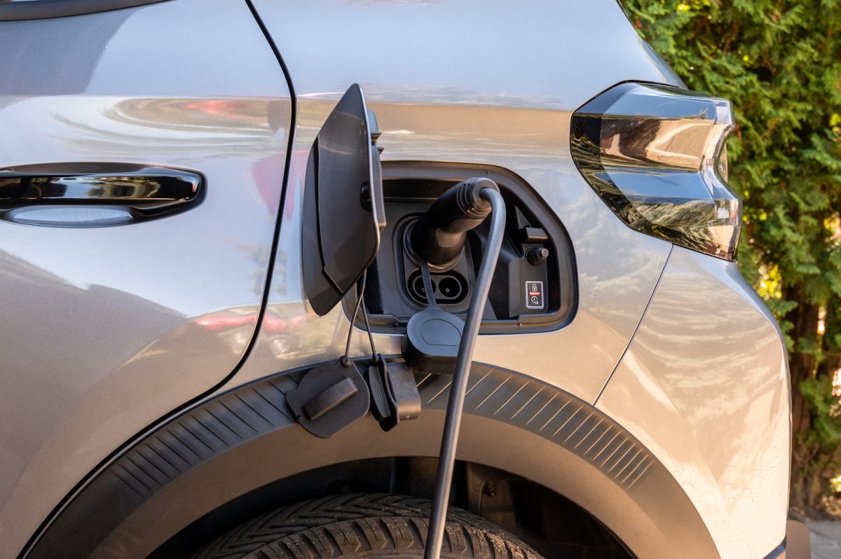 Electric car charging at home outdoors Electric vehicle plugged into a charger
