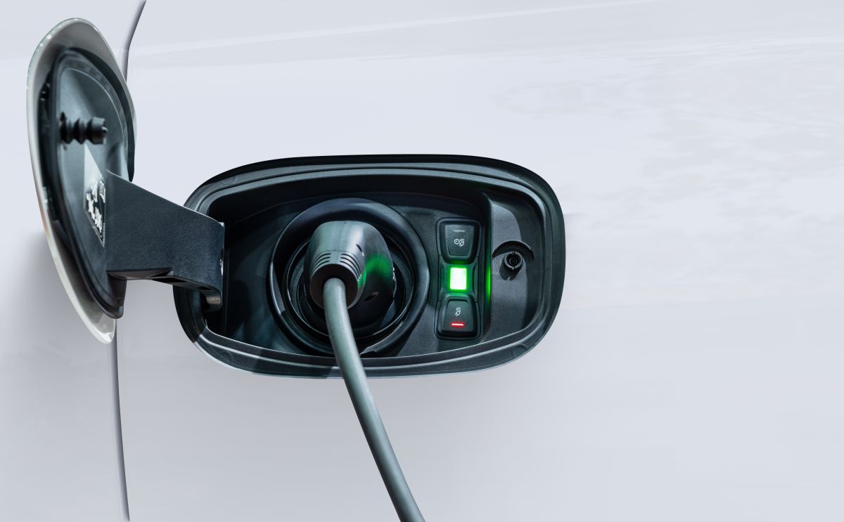 White electric car charging with copy space, Technology electric vehicle concept