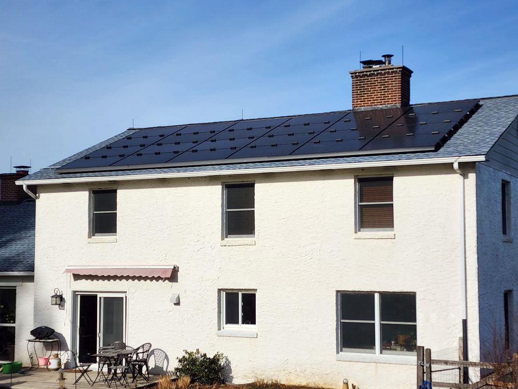 A house with solar panels on the roof, showcasing sustainable energy projects.
