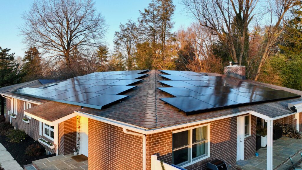 A house with solar panels on the roof for energy conservation and sustainability projects.